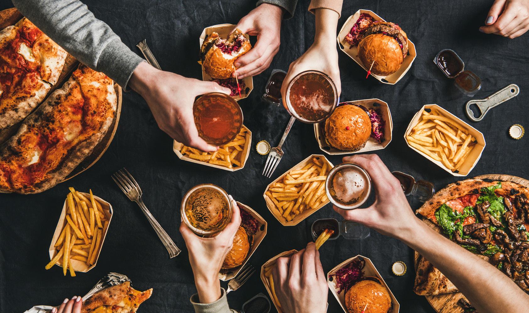 Large red and white sculpture outside a building, with a child looking at it.