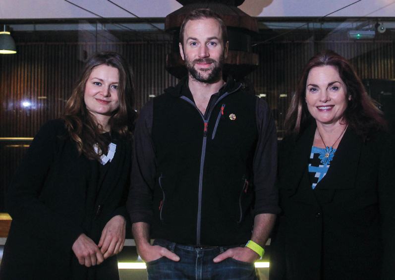 Three people, two women and one man, posing for a photo indoors, likely a team or leadership photo.