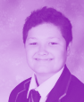 Headshot of a smiling young student wearing a school blazer and tie.